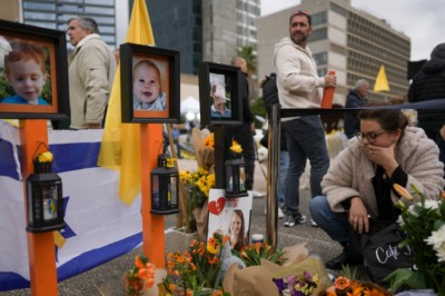 Israel mourns death of two youngest Hamas hostages; people wear orange bands